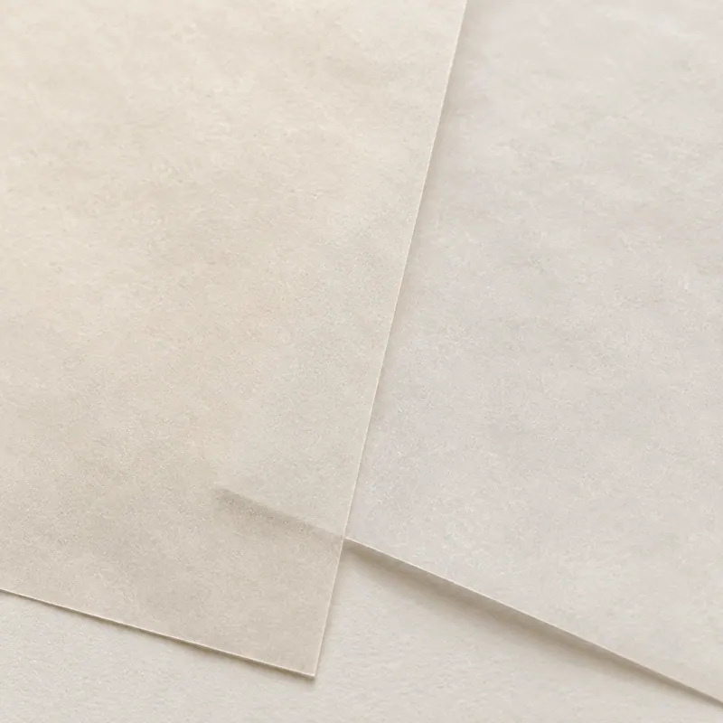 Two translucent sheets of paper laid over each other, slightly out of alignment.